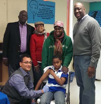 Dorchester YMCA-Carney Hospital Flu Clinic: l-r,  Kevin Washington, CEO YMCA of Greater Boston; Kathy Townsend, Executive Director Dorchester YMCA; Shirley Alexander Hunt; Andy Davis, CEO Carney Hospital; Dr. Miguel Concepcion and Xavier Alexander, receiving his flu shot.